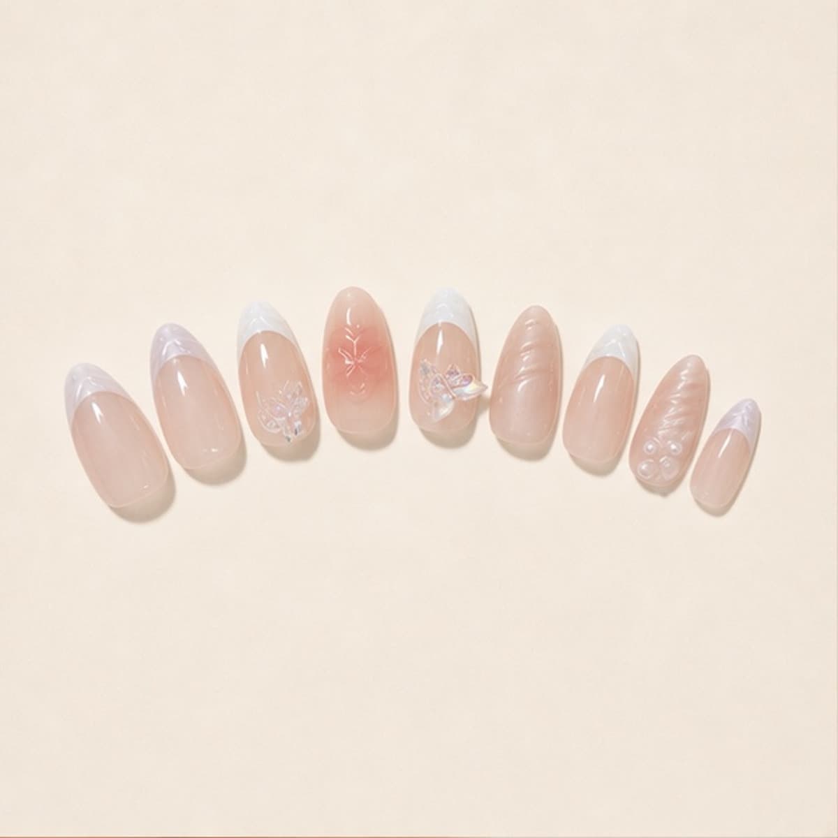 Fleur butterfly garden French press-on nail set arranged in a fan on an ivory background